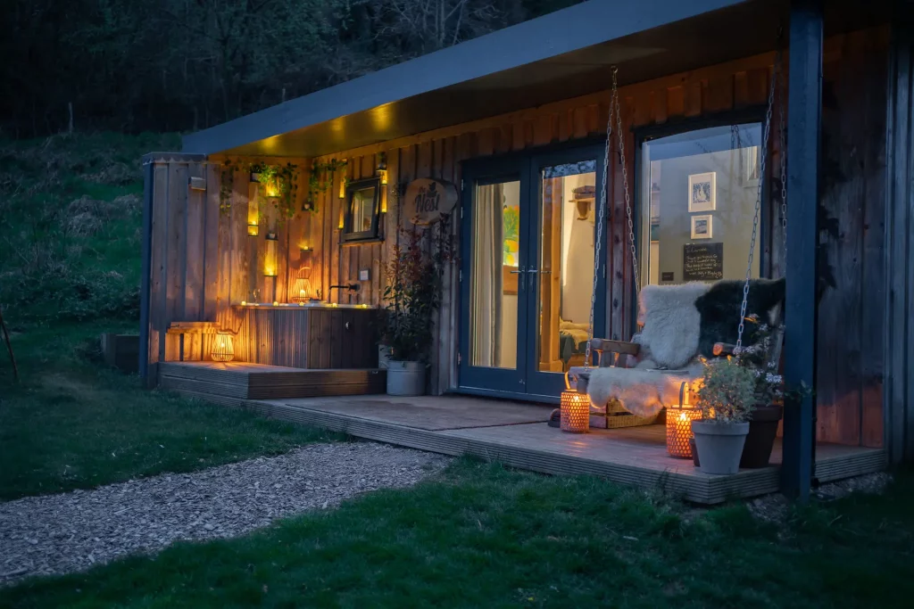 Nest veranda at dusk at The Roost Luxury Cabins